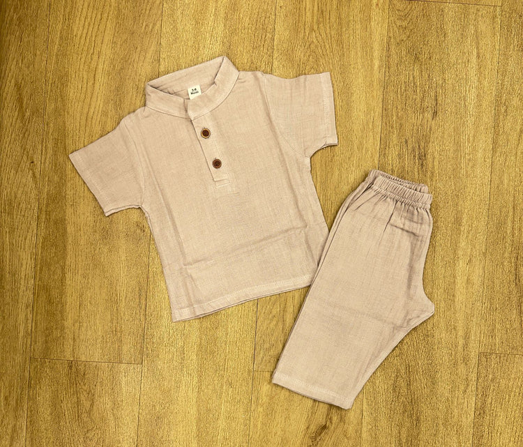 This image features is beige muslin co-ord set, consisting of a short-sleeve shirt and matching shorts.
