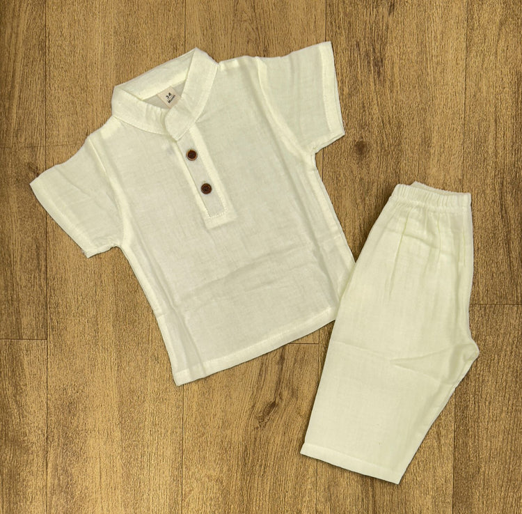 This image features is beige muslin co-ord set, consisting of a short-sleeve shirt and matching shorts.