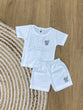 The item in the image is an (Magic train)Unisex Cotton Plain Baby Short Sleeves Suit & Short Pants. The small logo on both the shirt and shorts is a elephant.