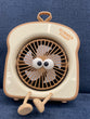 The item in the image is a "Summer Toast" mini portable fan, designed with an adorable toast shape and googly eyes.